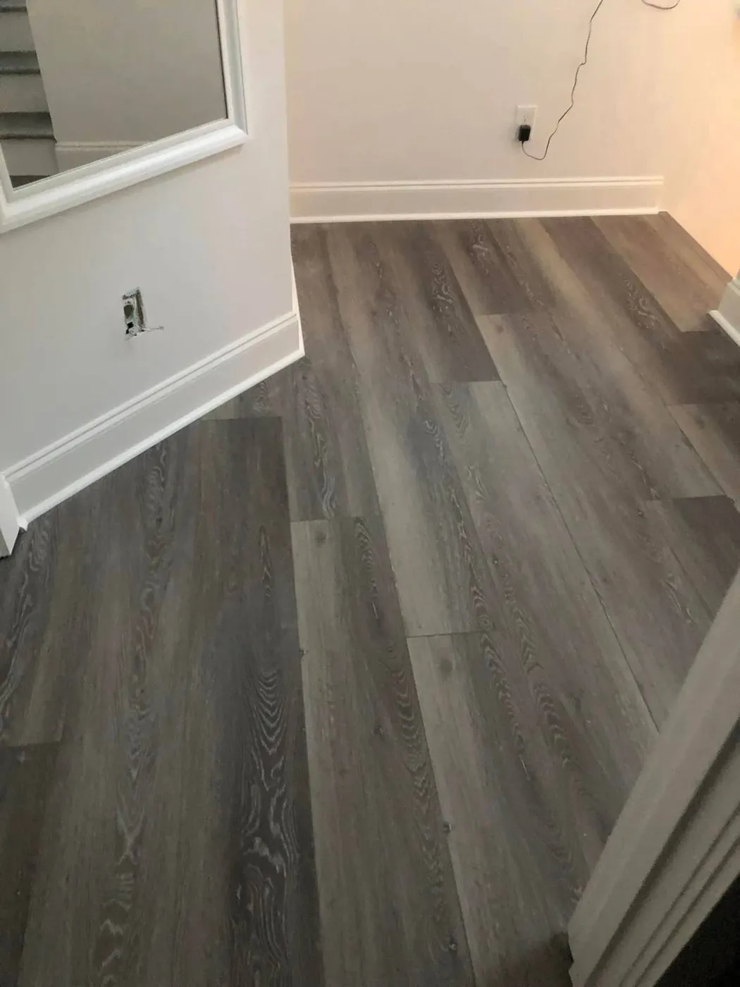 Gray luxury vinyl plank (LVP) flooring installation by Lesher Contracting in a Walton County, FL home