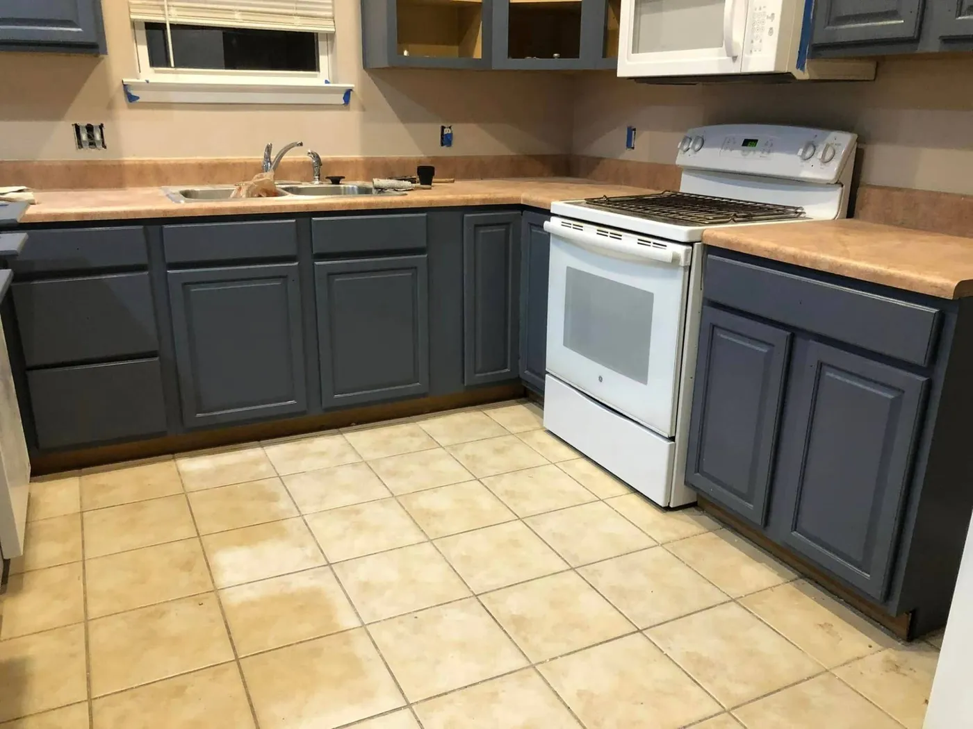 Refinished slate-blue kitchen cabinets in a 30A home remodel by Lesher Contracting