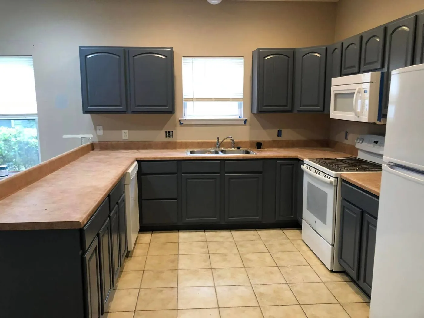 U-shaped kitchen renovation with painted cabinets by Lesher Contracting in Walton County, FL