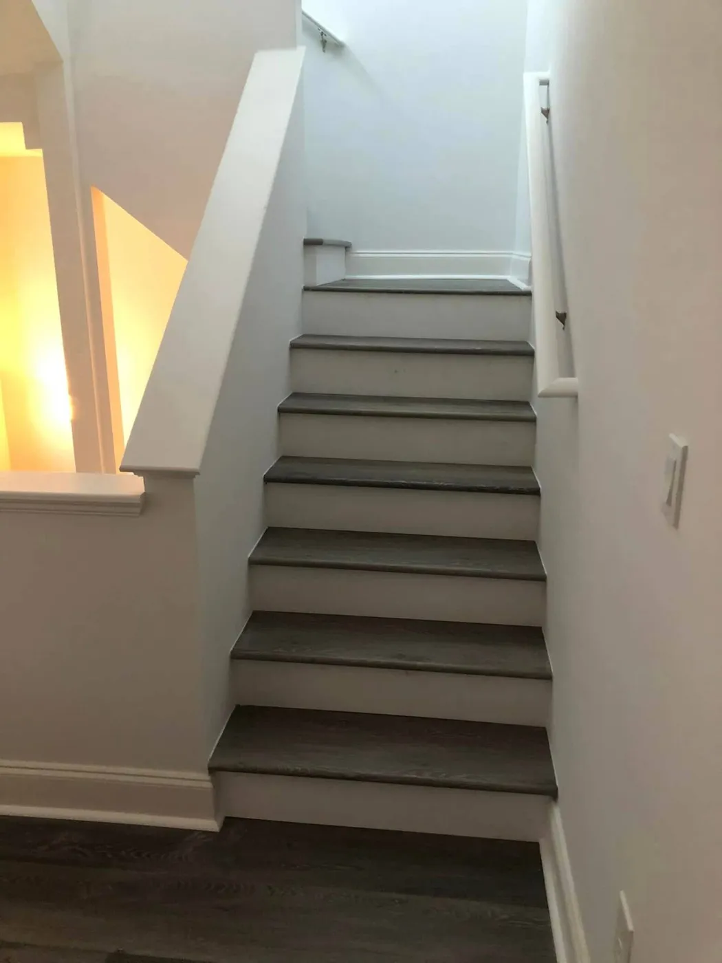 Refinished interior staircase with gray oak treads by Lesher Contracting in Santa Rosa Beach, FL